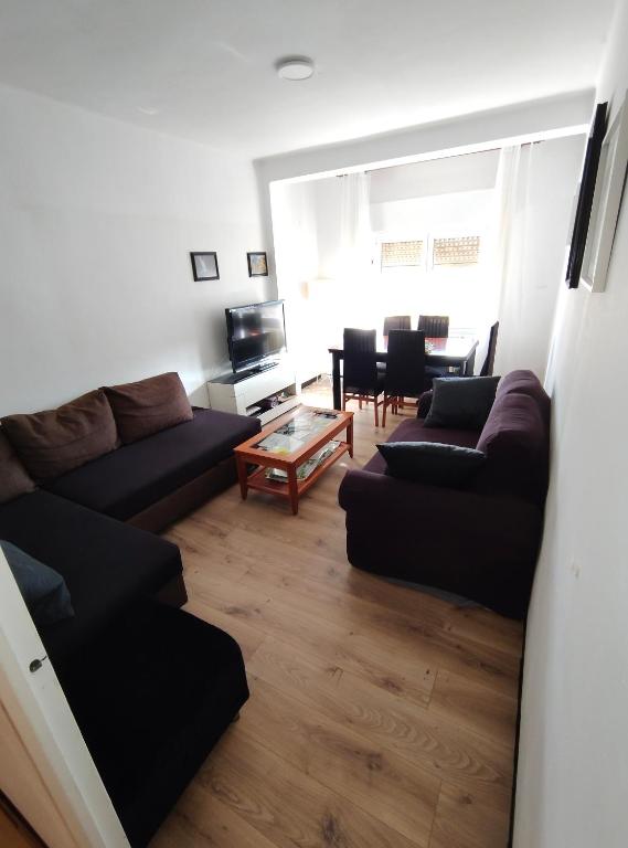 a living room with a couch and a table at Enjoy Pirineos in Huesca
