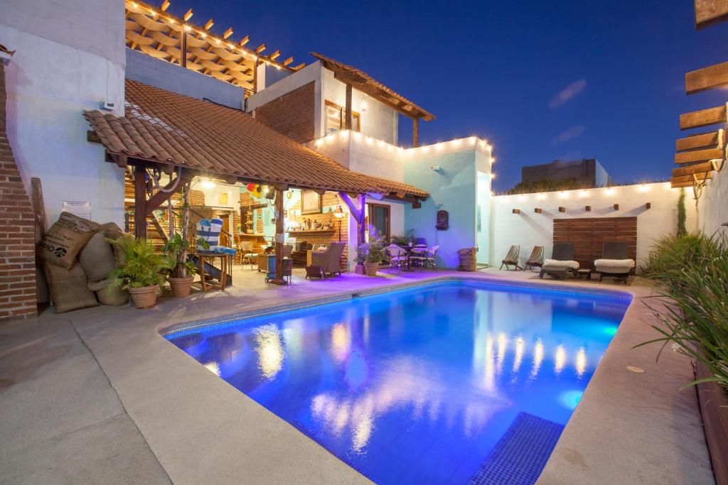 a swimming pool in front of a house at night at Aquamarina in La Paz