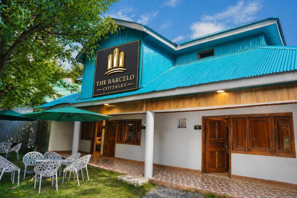 a restaurant with tables and chairs in front of a building at The Barcelo Apartment & Cottages in Naran