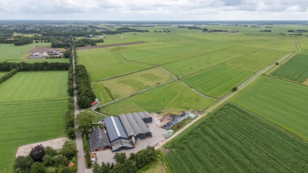 an aerial view of a farm with a house at Camping de Koaipleats in Akkerwoude