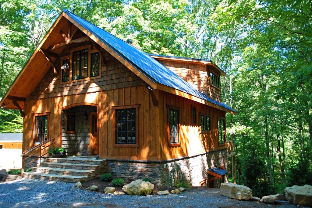 a wooden house with a blue roof at Timber Ridge in Franklin