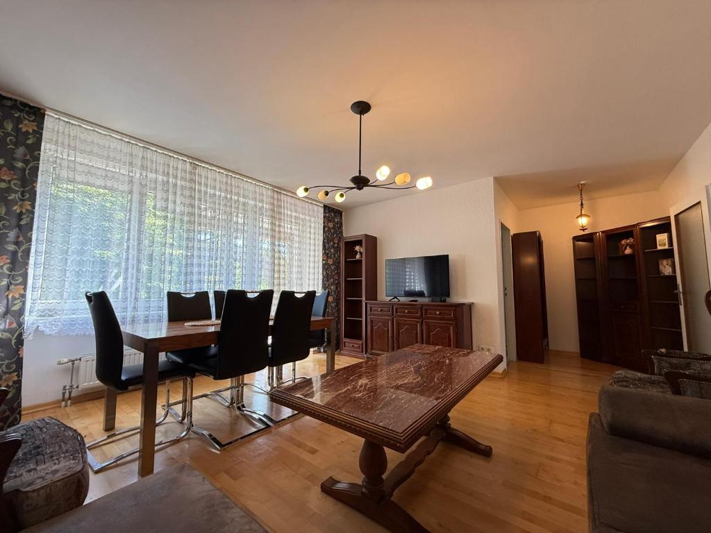 a living room with a dining room table and chairs at Altmodische 3 Zimmer Wohnung in Monheim