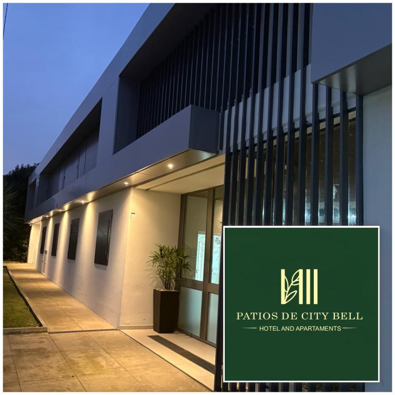 a building with a sign in front of it at Patios de City Bell Hotel and Apartments in City Bell