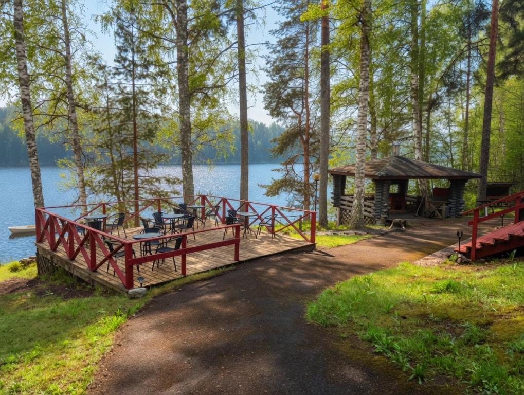 a dock with a gazebo next to a lake at Kyyronkaita in Mikkeli