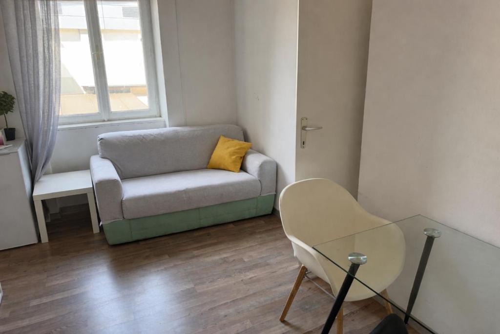 a living room with a couch and a glass table at PARIS in Ljubljana