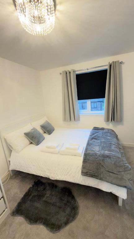a bedroom with a large bed with a window at Suite 2 En-suite Room with Double Bed in Edinburgh