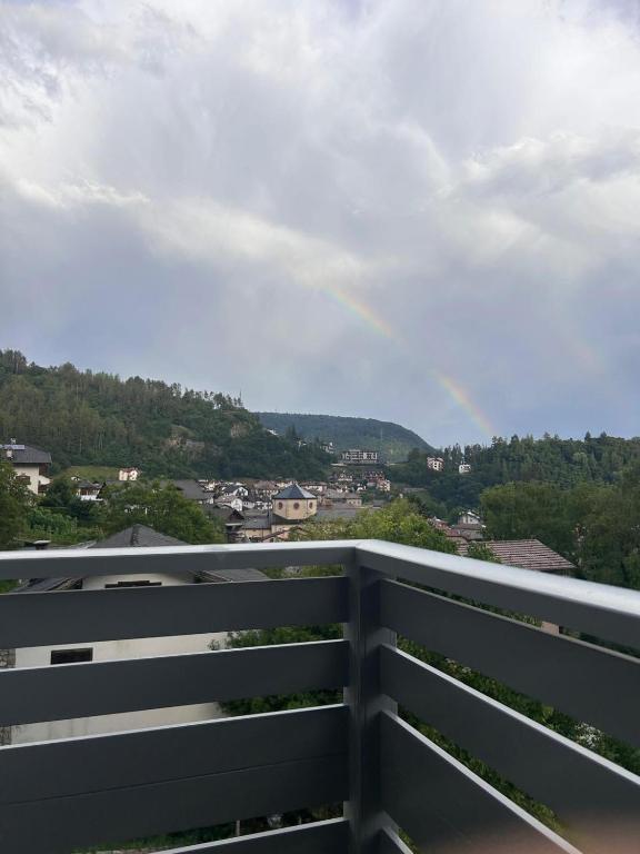 a rainbow in the sky over a city at Il Respiro del Brenta in San Lorenzo in Banale