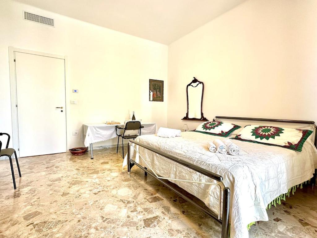 a bedroom with a large bed and a table at Casa della Nonna - Art & Vintage Rooms in Noicattaro