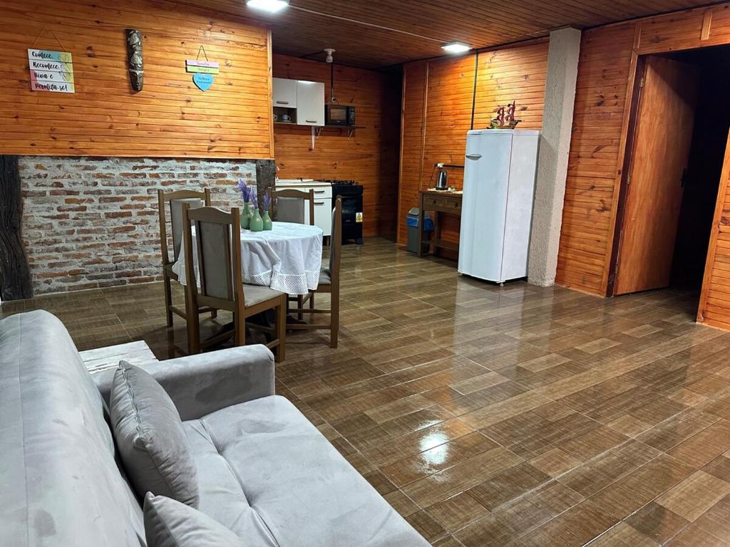 a living room with a couch and a table and a refrigerator at El Regreso in Chuí