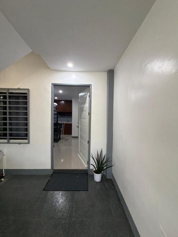 a hallway of a house with a door and a plant at stayhouse in Gapan