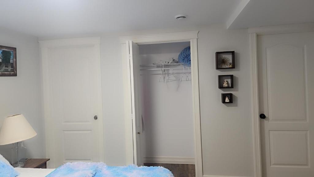 a bedroom with a door leading to a closet at Beautiful Home for all in Moncton