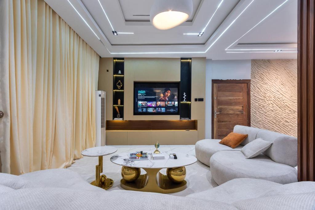 a living room with a couch and a table at Modern Luxury 2BR Spacious Cozy 24hr Power in Lekki