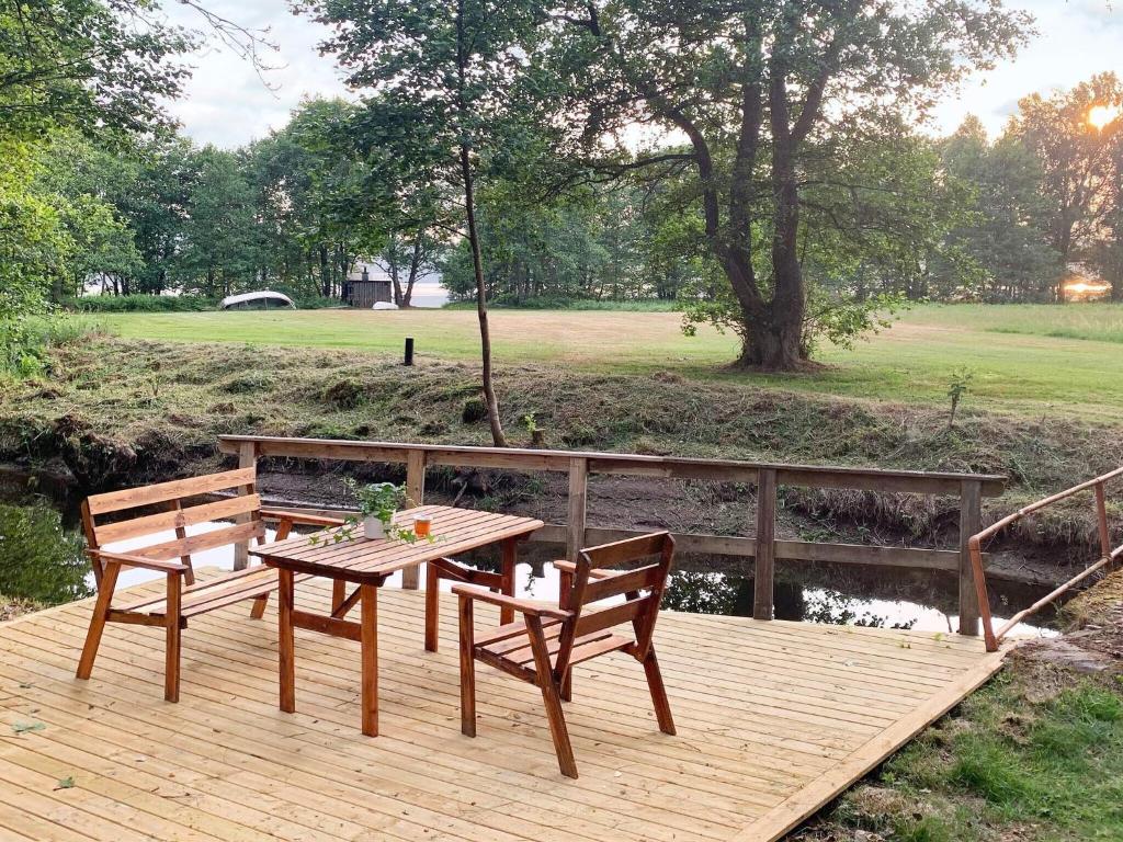a wooden deck with a table and two chairs at 6 person holiday home in Ucklum-By Traum in Ucklum