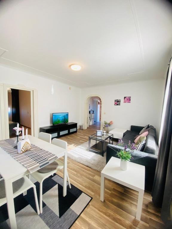 a living room with a couch and a table at Spacious House for Families & Workers in Skelleftehamn