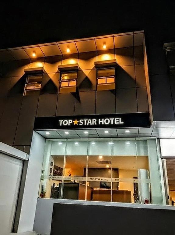 a top star hotel sign on the side of a building at Top Star Hotel Manaoag in Manaoag