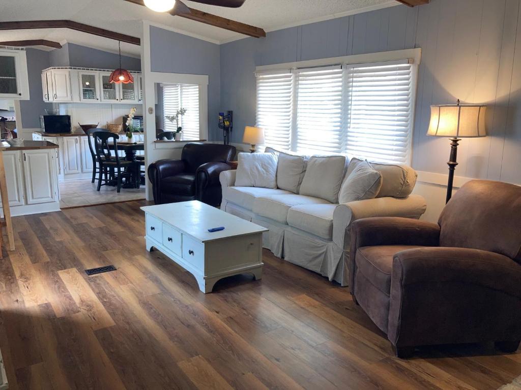 a living room with a couch and a table at Beaufort SC New Renovation, Close to Parris Island, Historic Downtown, Beautiful Beaches, Sleeps 6 in Beaufort