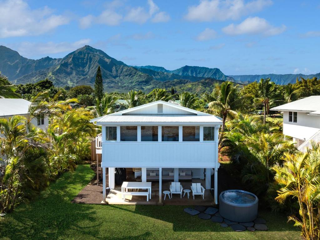 an aerial view of a house with mountains in the background at Cottage Three - Hidden Gem on Hanalei River in Hanalei