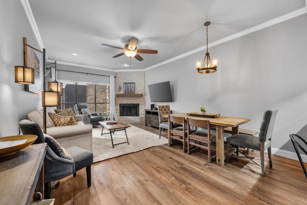 a living room and dining room with a dining table at Comal Rive Pool Gruene Hall by Barclé in New Braunfels