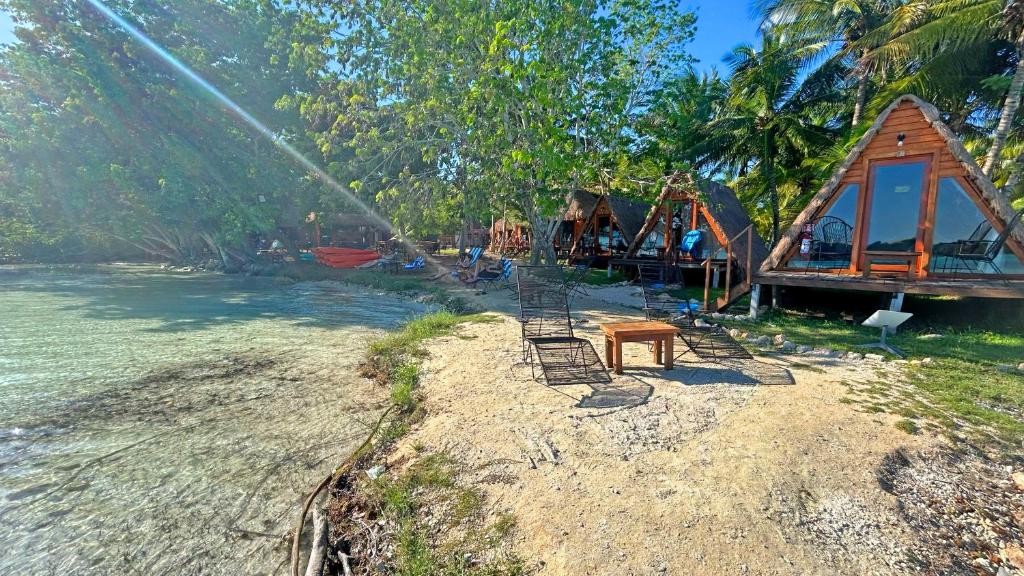 a group of children playing on a playground next to a house at Paradise Beach Bacalar A Pie De Laguna in Bacalar
