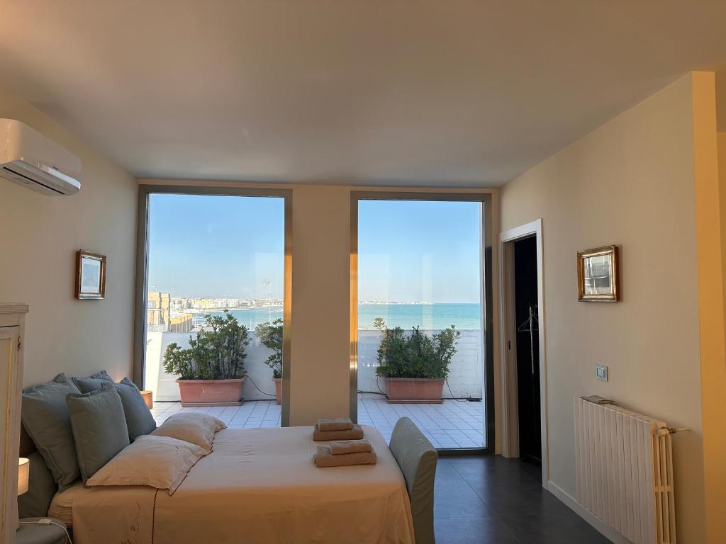 a living room with a couch and a large window at La mia terrazza sul mare - Mared'aMare in Bari