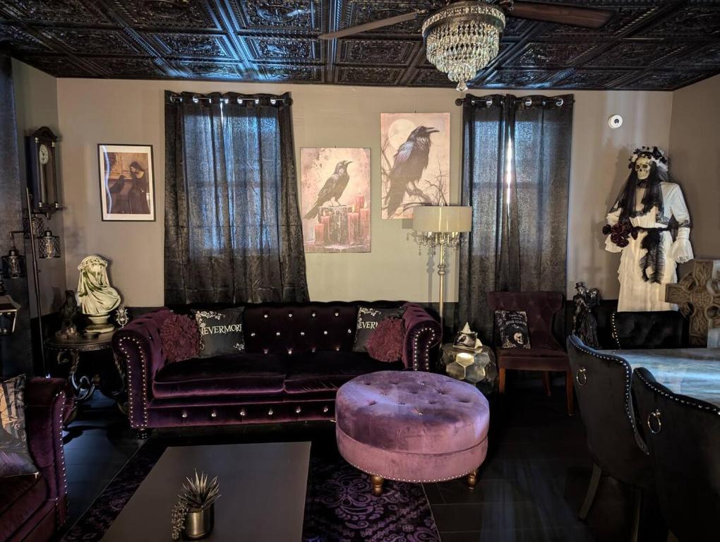 a living room with a couch and a purple stool at The Raven in Madison