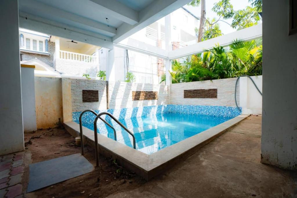 an empty swimming pool in a building at Classic Horizon in Mahabalipuram