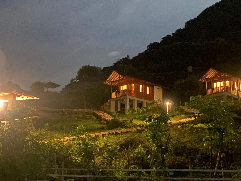 a couple of houses on a hill at night at Saluvi Hill's in Pulau Sarang