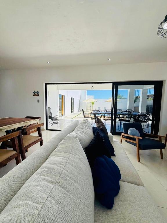 a large couch in a living room with a table at Casa Flamingo, San Carlos in San Carlos