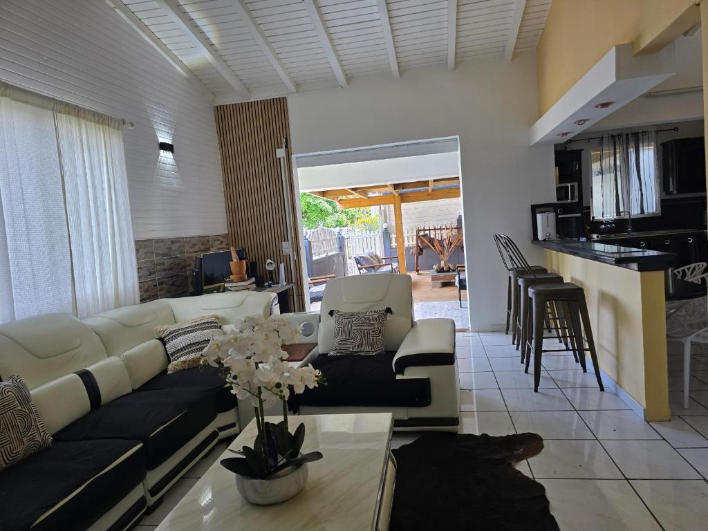 a living room with a couch and a table at Villa Chelsy in Capesterre-Belle-Eau