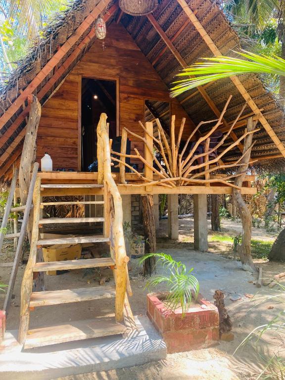 a wooden hut with a staircase in front of it at Lakdina Lodge in Panama