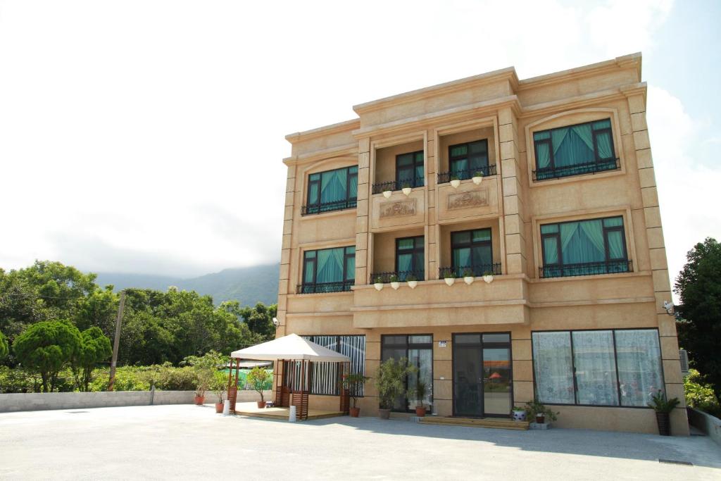 a large building with a canopy in front of it at Stick-On B&B in Shunan