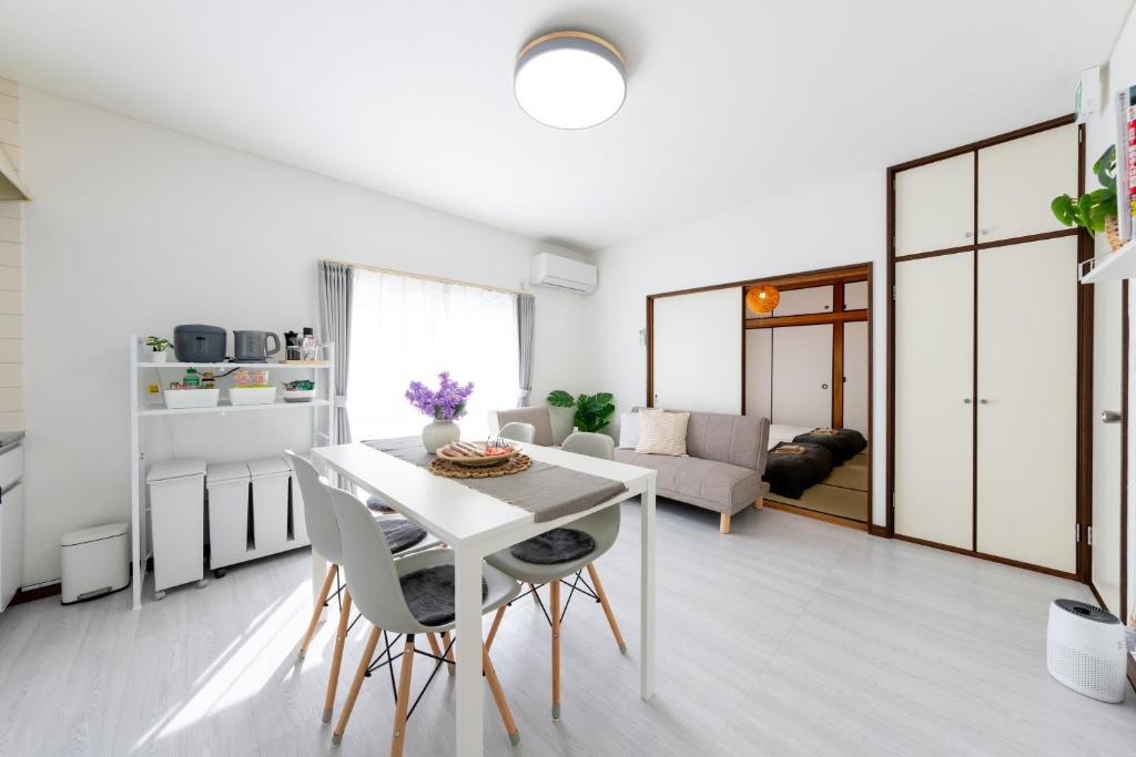 a kitchen and living room with a white table and chairs at Coto House Kamakura RoomB in Kamakura
