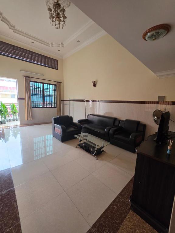 a living room with a couch and a table at Toul Sleng Double Room in Phnom Penh