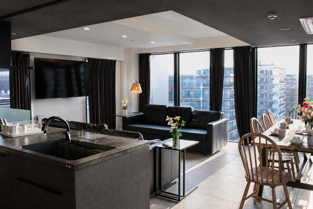 a kitchen and living room with a couch at 大阪難波リバーサイドガーデンホテルOsaka Namba River Side Garden Hotel in Osaka
