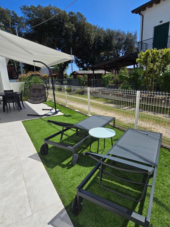 two ping pong tables and a swing in a yard at Home23Jesolo! Beach, Parking and Bikes included in Lido di Jesolo