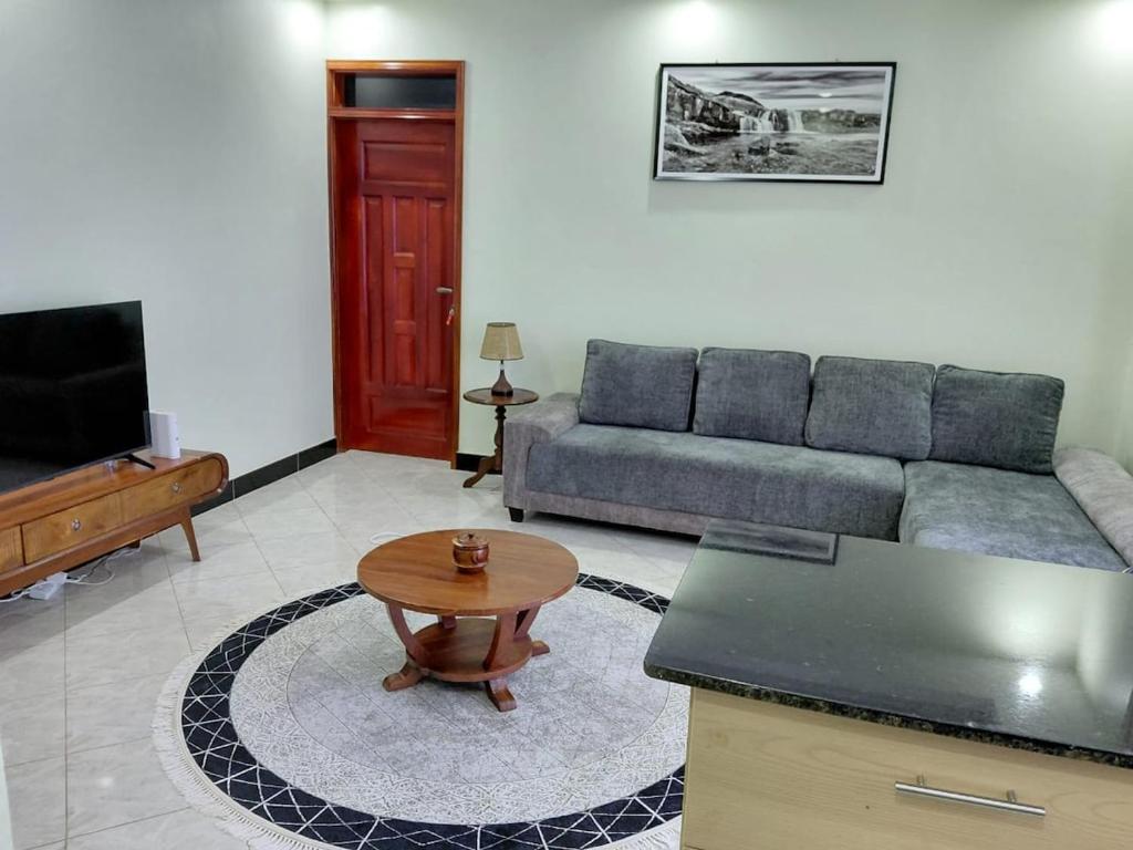 a living room with a couch and a table at Keirwa in Kampala