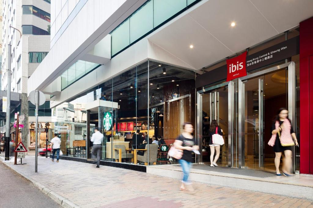people walking in front of aidas store on a city street at Ibis Hong Kong Central & Sheung Wan in Hong Kong