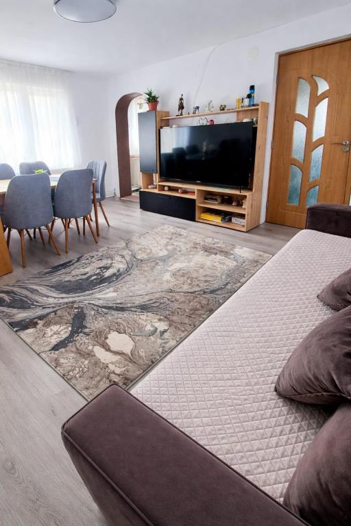 a living room with a tv and a bed at Casa Vatra Dornei in Vatra Dornei