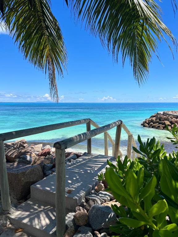 a pathway leading to a beach with the ocean at Sunset Cove Villa in Grand'Anse Praslin