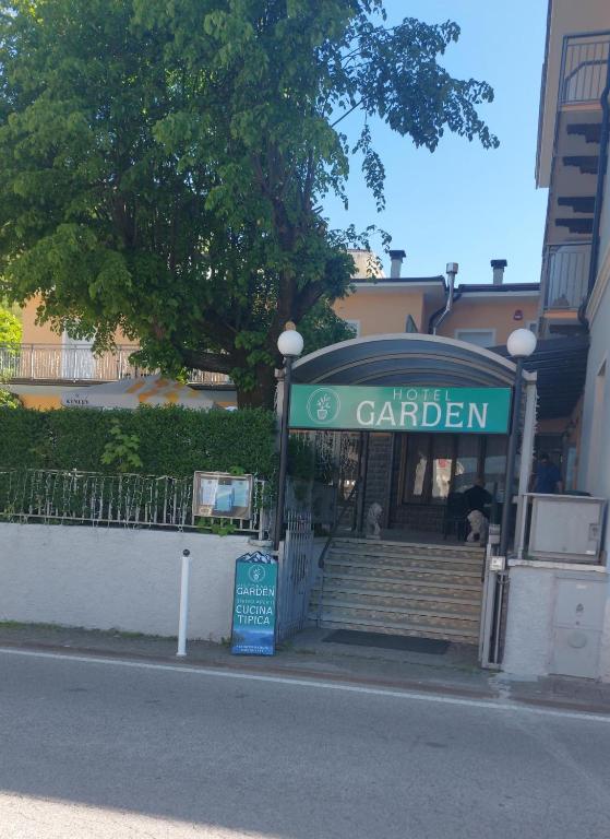 a building with a sign for a car dealer at Hotel Garden in Levico Terme