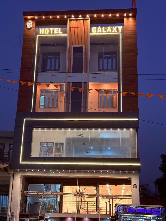 a building with a hotel with lights on it at Hotel Galaxy in Mundarwa