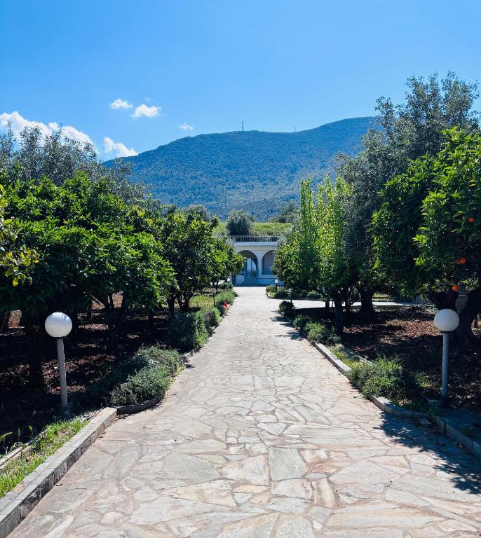 a cobblestone path in a garden with a house at Casa Crystallia in Chalkida