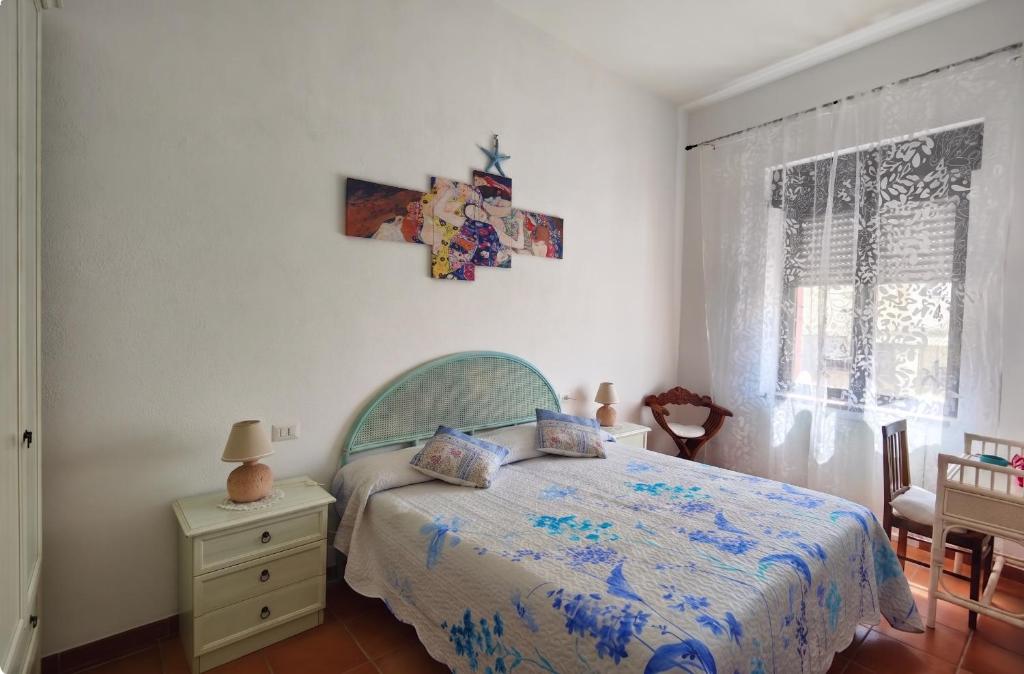 a bedroom with a bed and a table with a night stand at Maisonette Asfodelo in Palau