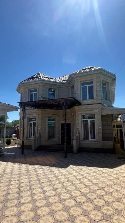 a large house sitting on top of a driveway at Гостевой дом in Tokmok