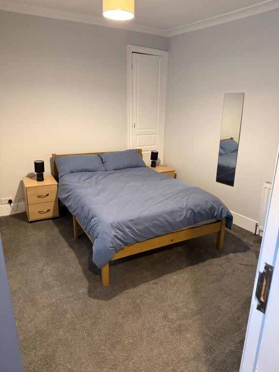 a bedroom with a bed and two night stands at St Andrew's Lettings in Peterhead