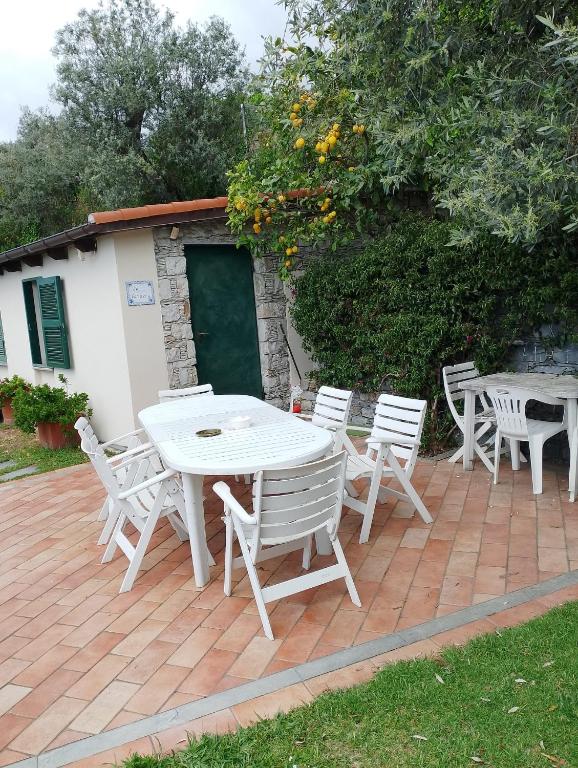 a white table and chairs on a patio at la Baracca in Genoa