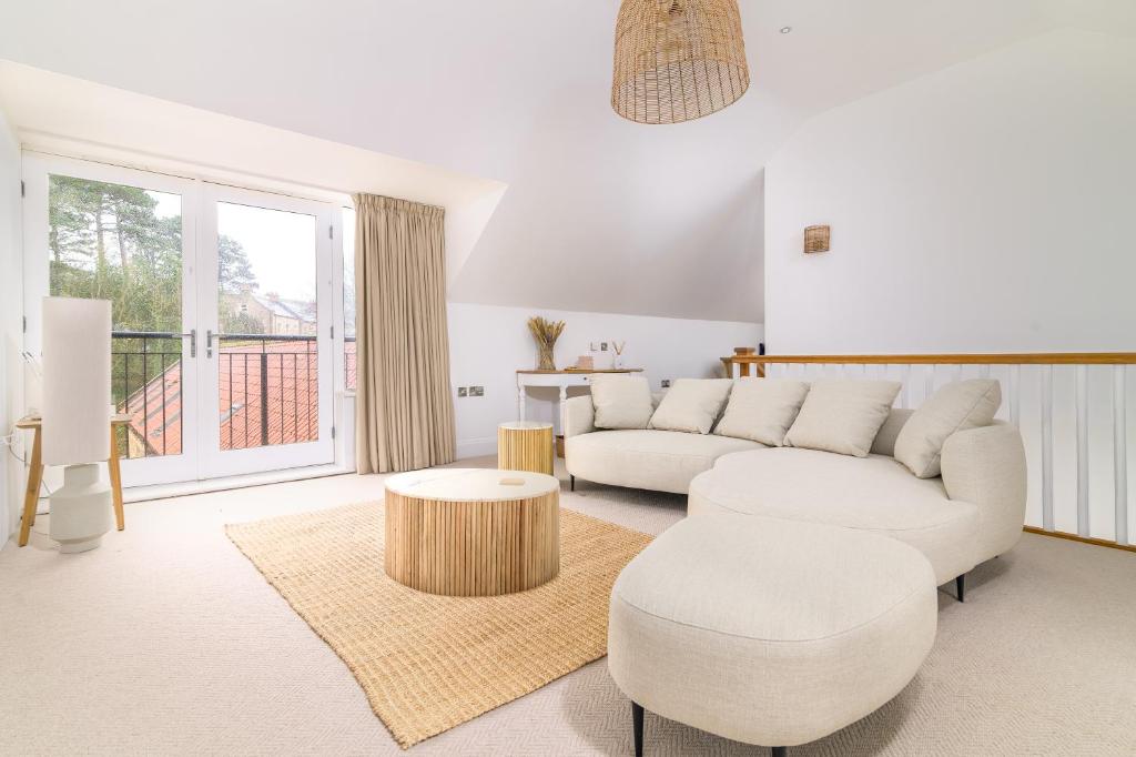 a living room with a couch and a table at Sandsend Retreats at Saltmoore in Sandsend