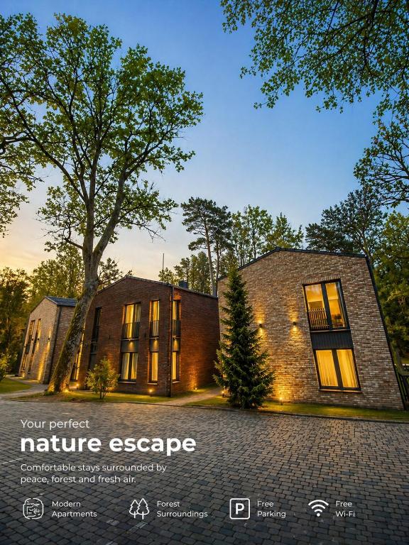 a brick house with a tree in front of it at Klaipeda Seaside Apartments with self check-in in Klaipėda