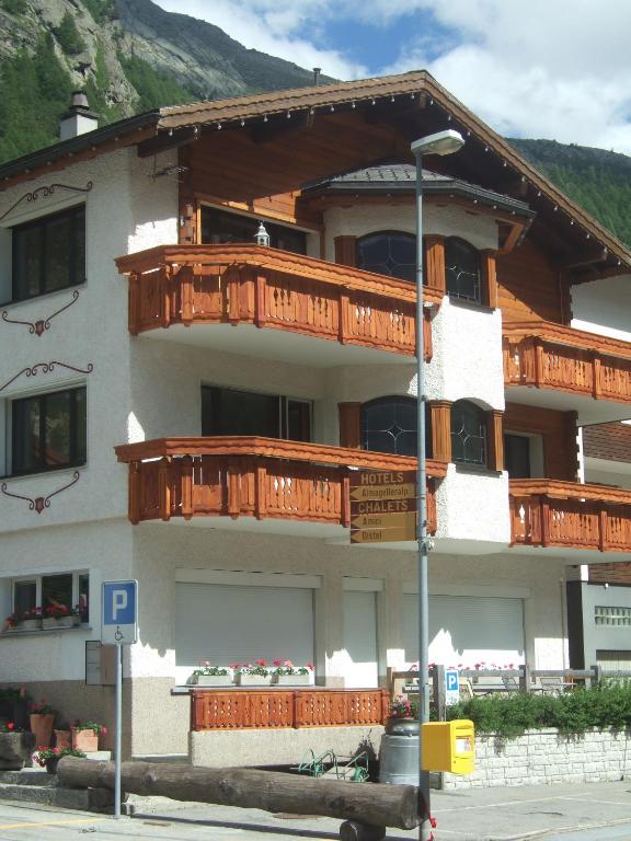 a building with wooden balconies on the side of it at Apartment Theresli First Floor in Saas-Almagell