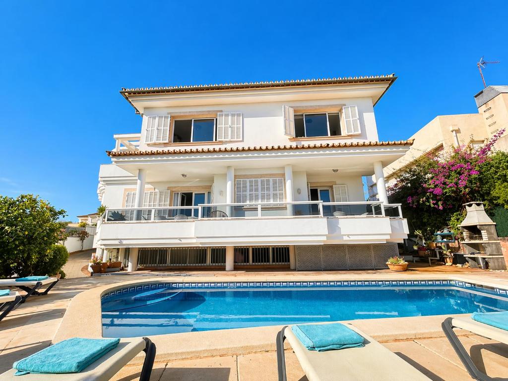 a villa with a swimming pool in front of a house at Villa Filipinas ,CITY CENTER -ETV10310 in Palma de Mallorca